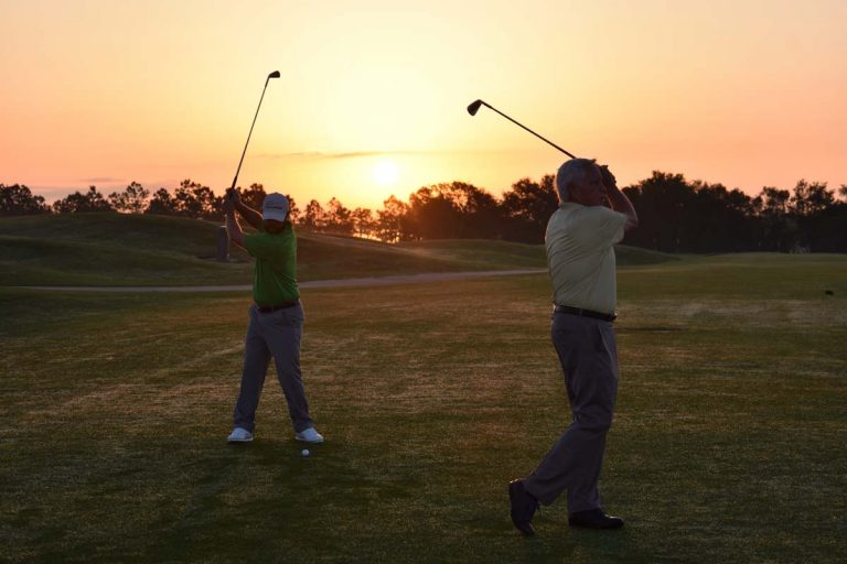 Daniel & David Lee swinging golf clubs
